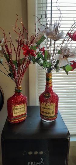 Glitter decorated flower vase liquor bottles.