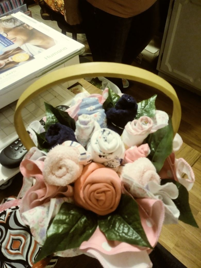 Basket of flowered burp cloths and onies boy or girl