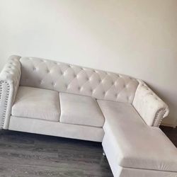 Rhinestone crème velvet sectional 2 little spots on couch not noticeable covered by pillow/ Glass Table 