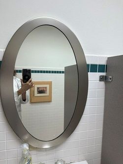 27.Brushed stainless steel (or aluminum) oval wall mirror