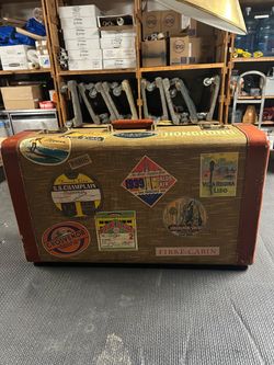 Old luggage with stickers 14” height 24” length 7 width