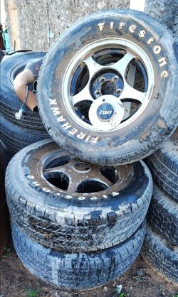 2 sets of Ford rims with tires