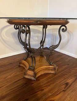 Wood and Iron dinning room table with glass top