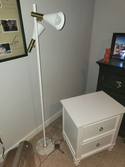 White side dresser with white and gold lamp