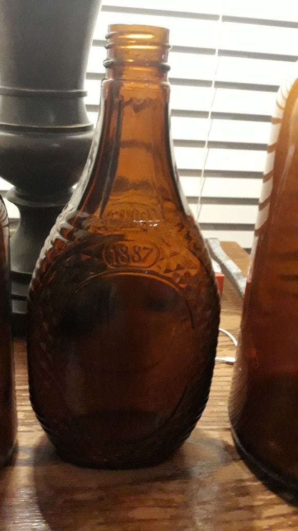 Old vintage log cabin syrup bottle