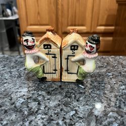 Vintage Hobo on an Outhouse Salt and Pepper Shakers.  Size approximately 3 inches tall.  Preowned Good Condition. 