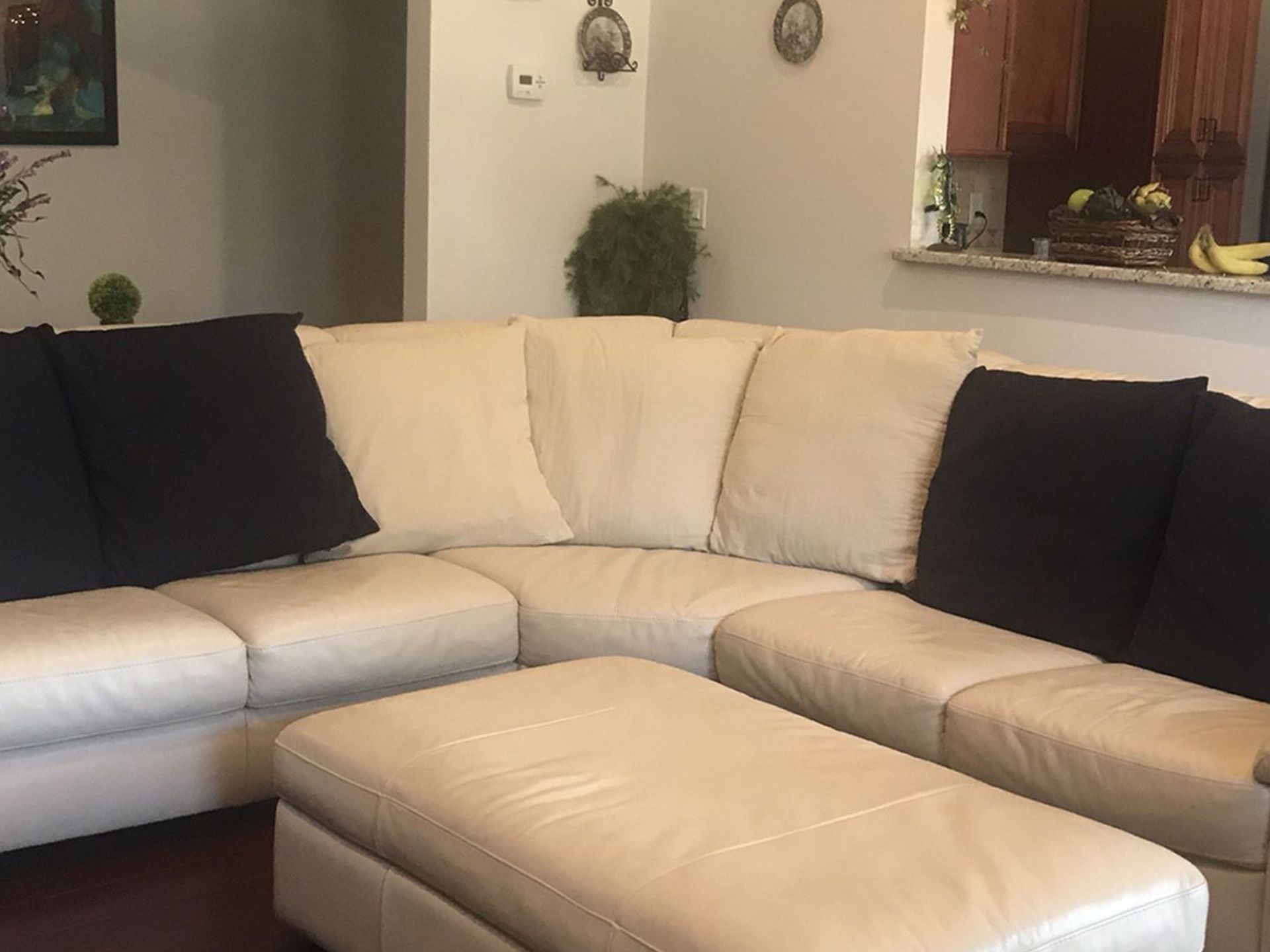 Italsofa sectional with 7 Large pillows, bought at Macy’s, In excellent condition, leather large Ottoman with storage space included