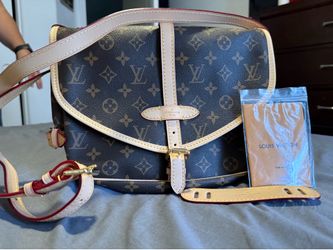Louis Vuitton Saumur, a classic saddle-style messenger bag featuring the iconic Monogram canvas
