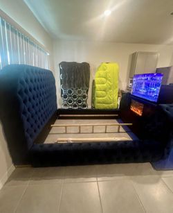 Blue tufted fireplace queen sleigh bed