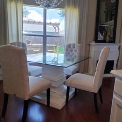 Custom made pedestal,  glass top table, and light cream upholstered chairs 