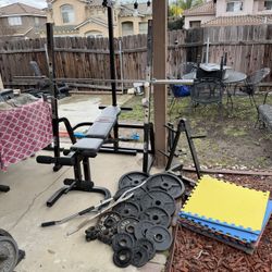 Bench press squat rack with pulley system 265lbs of Olympic plates and 7ft 40lb bar plus weight tree and mats