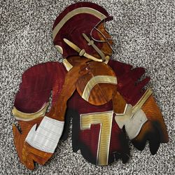The piece is known as the "Redskins Joe Theismann #7 Metal Wall Art" produced by Elements.