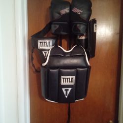 Adult Title Boxing Vest And Cup. Both Have Adjustable Straps.  Medium Shin Guards.  UFC Boxing Gloves 12 Oz. All For 
