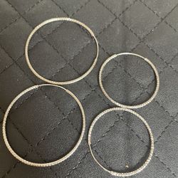 Two pairs of silver hoop earrings 