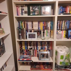 White Shelf With Various VHS Tapes