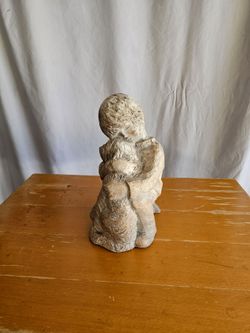 Statue of Boy Hugging Dog