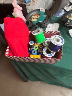 assorted sewing and crafting supplies, including spools of thread,
