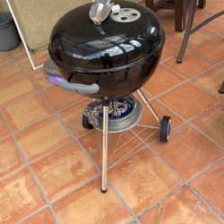 Weber barbecue with utensils