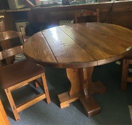 A round Top table with 4 chairs. Vintage wooden table and chairs. Used but in good condition