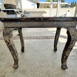 (25Hx28Wx18D) pretty Rustic Table w/ beautiful designing on the legs. Located in Yucaipa.