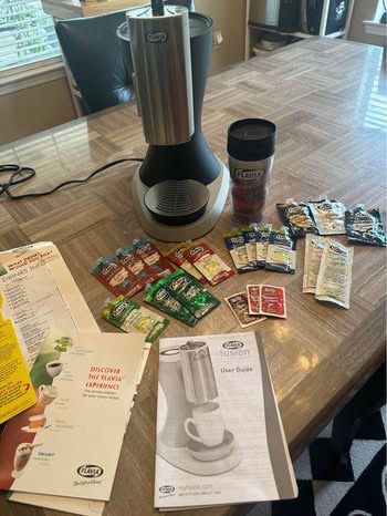 Flavia Fusion Coffee Maker with manual guides, extra coffees, teas, espresso, syrups, sprinkles and licensed travel thermos. Nothing wrong with unit,