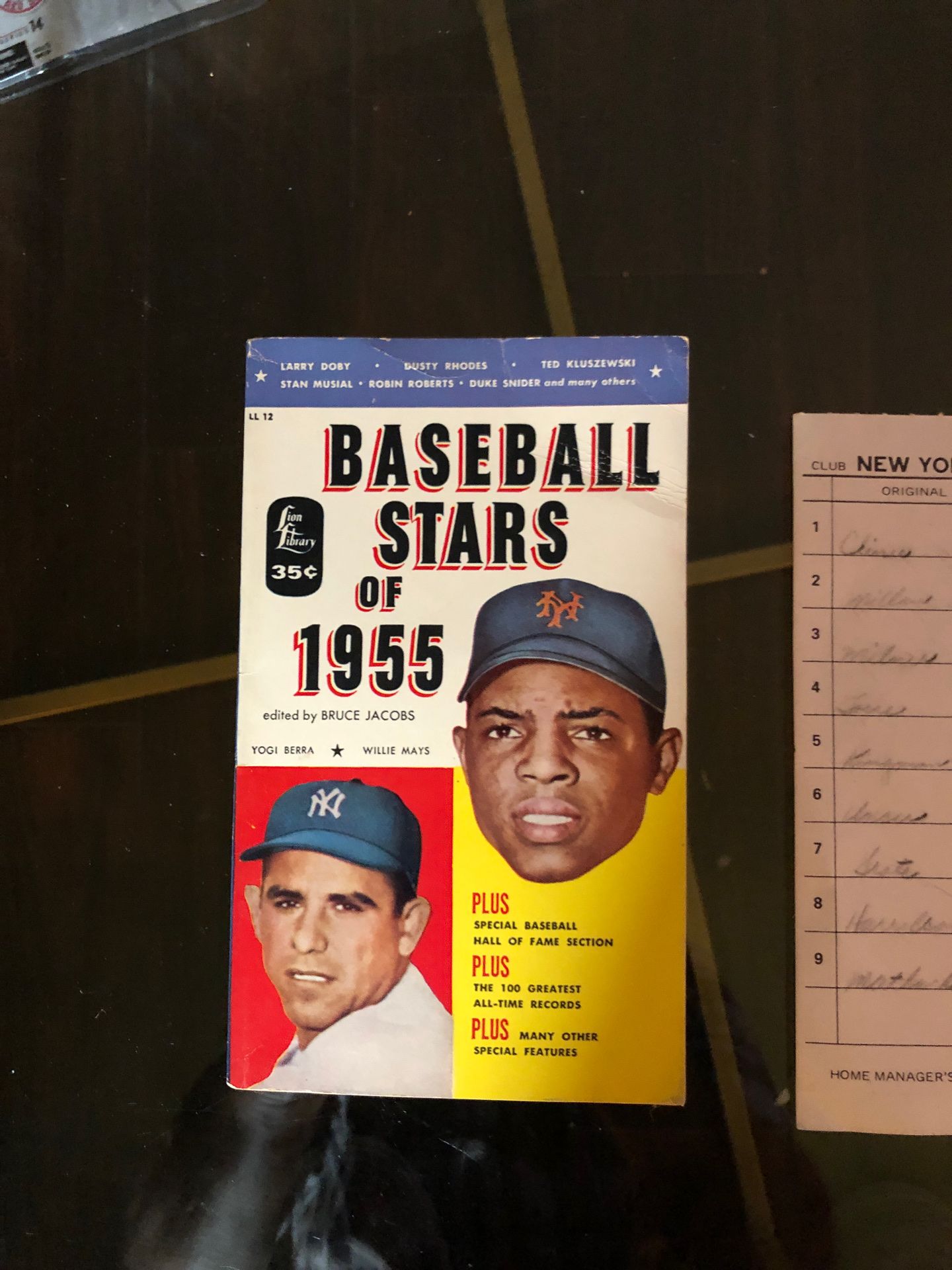 Vintage baseball books : line up card signed by Berra 1975