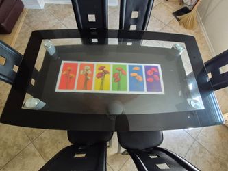 Glass top dinning table with 6 leather chairs