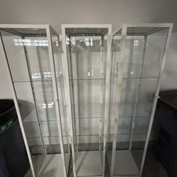 3 Modern Glass & Metal Curio Cabinets – Magnetic Doors, Excellent Condition – Sold Together or Separately