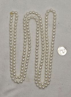 59" White beads continuous strand.
