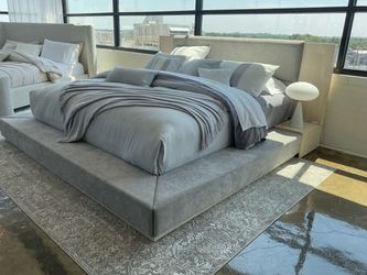 New king size gray color fabric upholstered platform bed.
