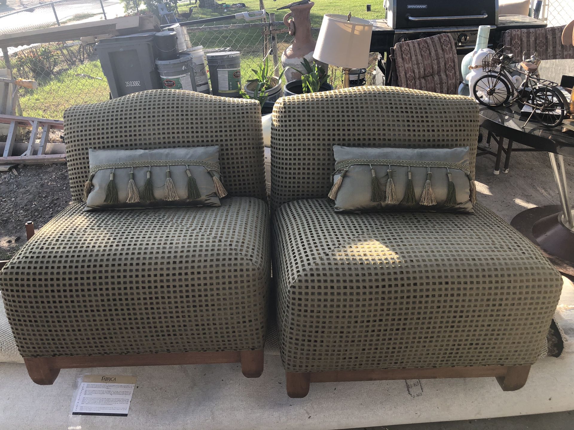 2 green individual sofas with small pillows