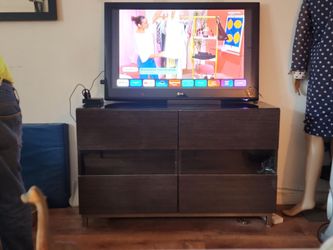 Black and gray console to place TV with shelving inside