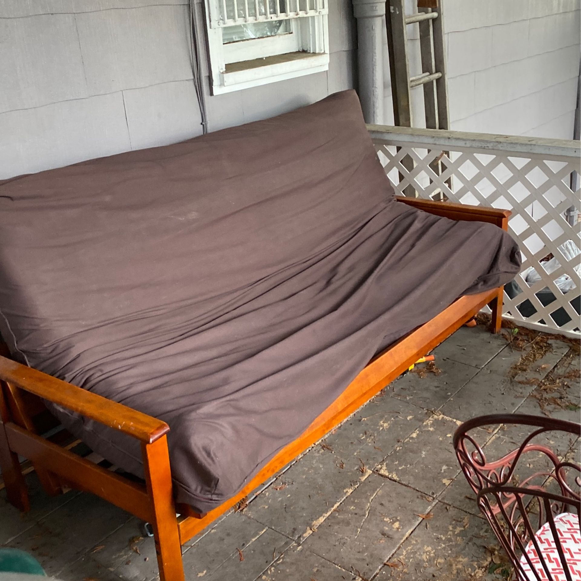 Wood Framed Futon With Mattress And Brown Cover. Seats 3 Comfortably.