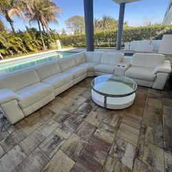 White couch with black chairs