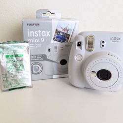 White Instax Mini 9 camera with film