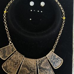 Elegant gold necklace with textured pendants. Perfect for any occasion.