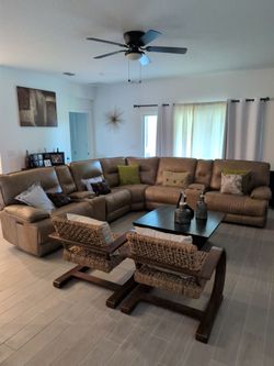 L shaped leather couch with 3 recliner sections and 2 storage sections with drink holders.