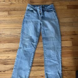 High-waisted blue denim jeans with frayed hem. Size zero