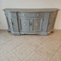 French provincial style sideboard features a gray painted finish with gold accents and crystal-style knobs