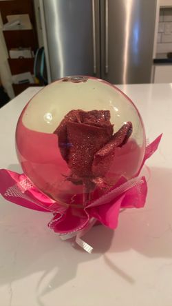 Real rose coated in glitter in water ball