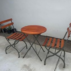 round redwood wooden bistro tables with 2 chairs each (2 matching sets)