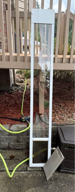Dog door insert for a sliding door