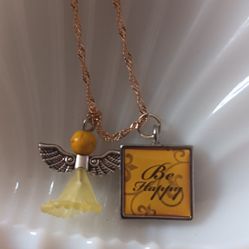 Cute Little Angel With A Be Happy Sign On A Gold Chain