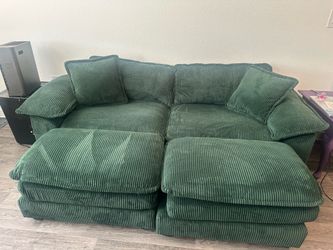 Green couch with two ottomans