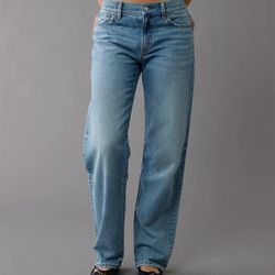 The AE Strigid Low-Rise Ex-Boyfriend Jean in size 000 is a brand new pair of women's jeans from American Eagle Outfitters. These solid blue denim jean