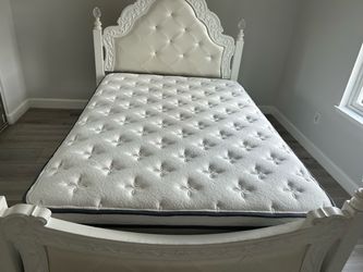 Full size bed frame with mattress and matching lamp stand