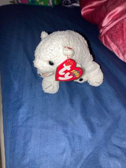 Beanie Baby "Aurora" the polar bear, released in 2000.The bear features black button eyes, a black nose, and a small pink mouth, with the birthdate of