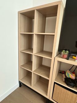 IKEA KALLAX 8-cube shelving unit in white-stained oak effect, including black metal base/stand.