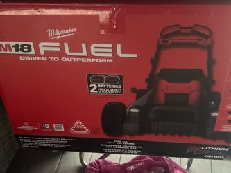 Brand  new  Milwaukee M18 lawn mower in the box comes with two 12.0 forge lithium batteries with charger