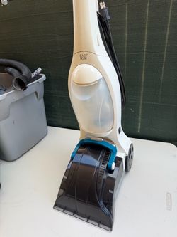 Easy Home upright carpet cleaner featuring a white and translucent body with a dark grey and teal recovery nozzle base.